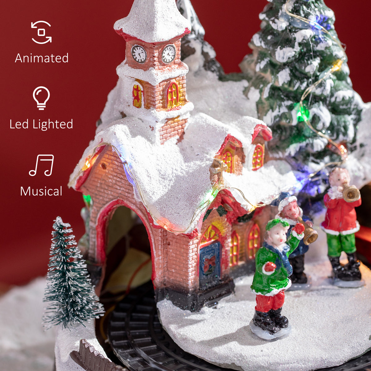 Decoración de pueblo navideño con tren giratorio y música